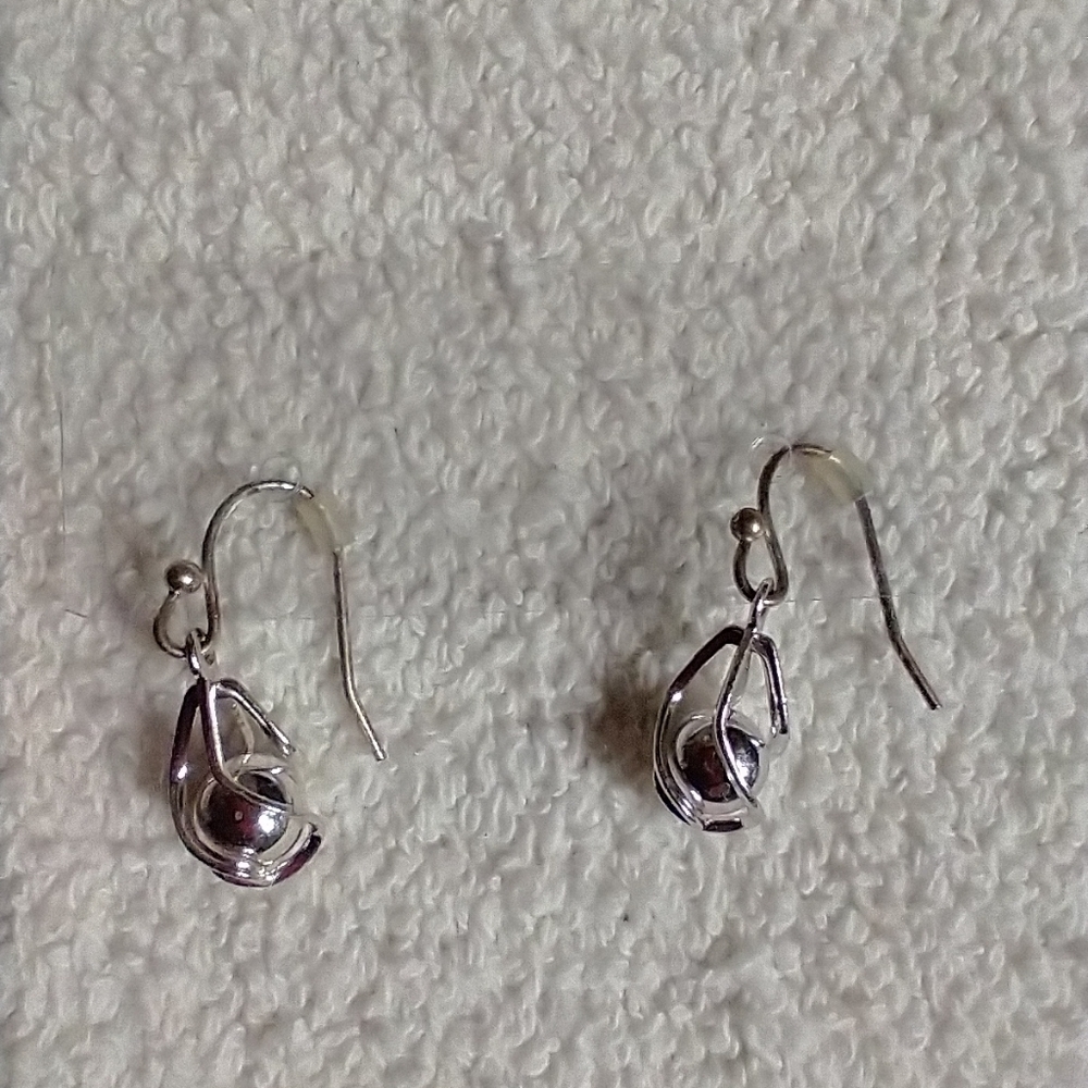 Silvertone swirl ball caged wire earrings